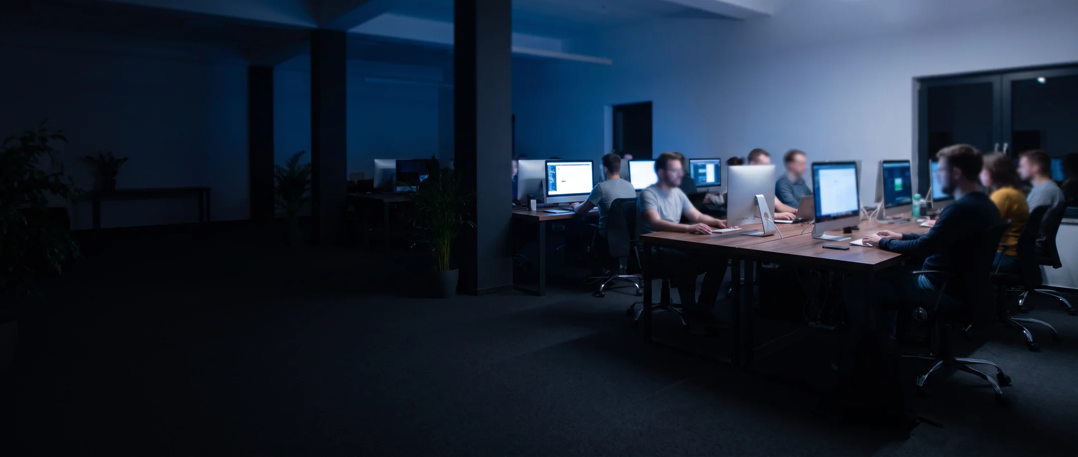 An agency team working together across a bank of desks